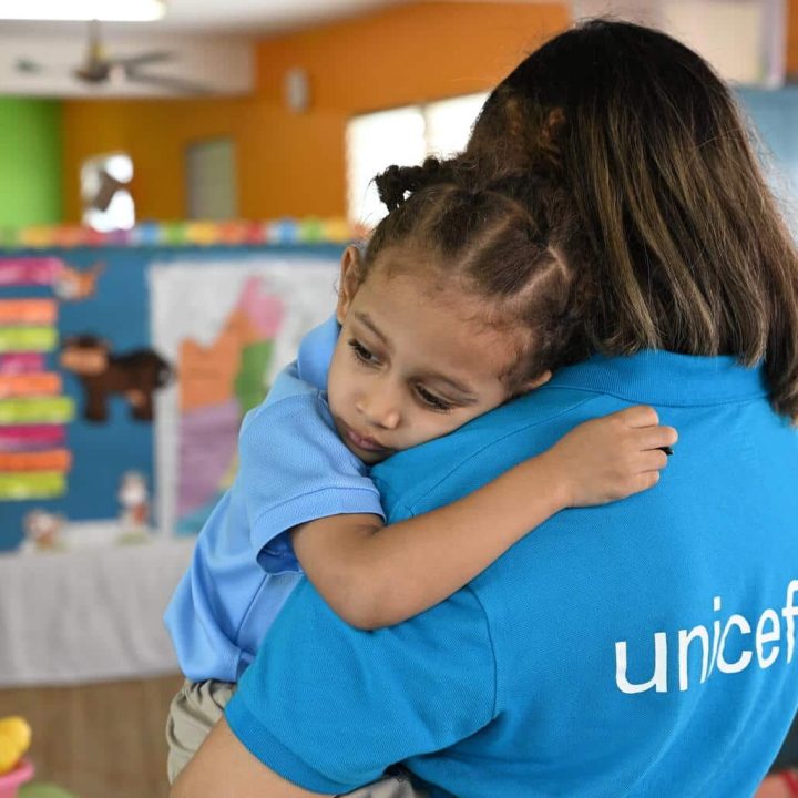 Un membre du personnel de l'UNICEF est avec un enfant dans une école maternelle à Belize City, la plus grande ville du Belize. © UNICEF/UNI594328/Dejongh