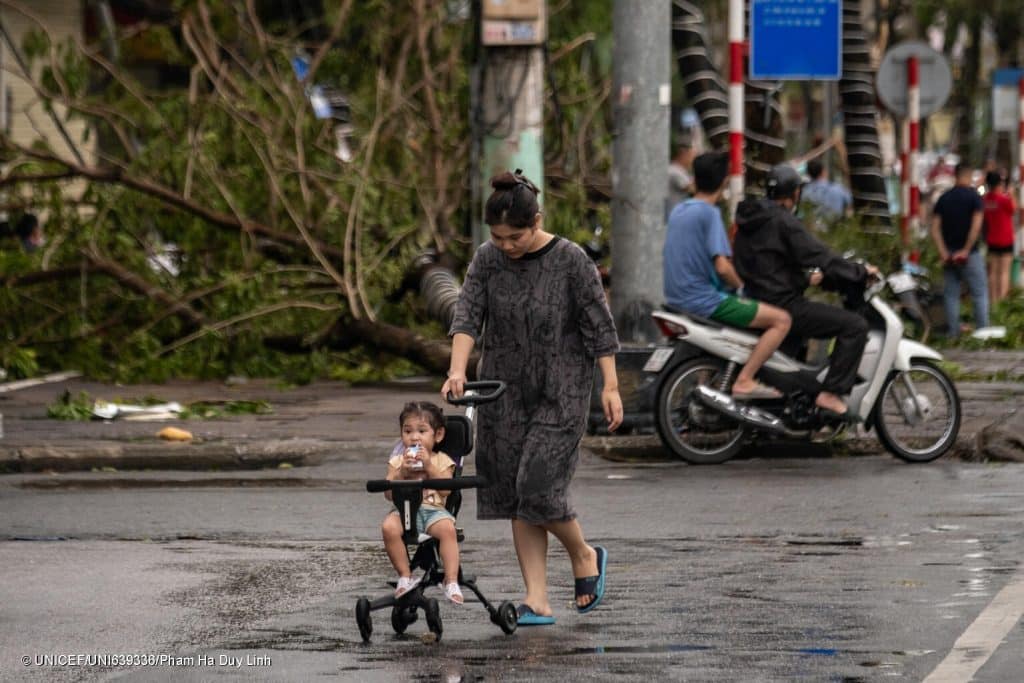 Des personnes et des enfants dans les rues de Cẩm Phả, suite au passage du typhon Yagi qui a frappé le Vietnam, le 8 septembre 2024. © UNICEF/UNI639336/Pham Ha Duy Linh